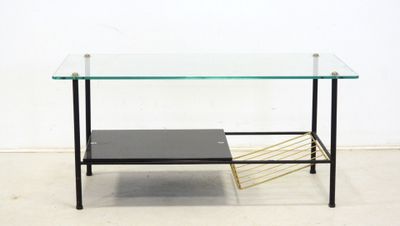 an image of a glass coffee table with a magazine rack underneath it
