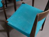 a blue chair that is sitting in front of a table
