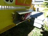 a yellow truck with a sign on the side of it