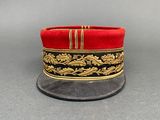 a close up of a red hat with gold trim