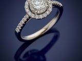 a diamond and white gold ring with a halo setting