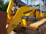 a yellow bulldozer that is parked in a lot