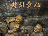 a statue of a boy and a boy with a fishing pole
