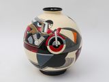 a vase with a motorcycle painted on it on a white surface