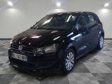 the black volkswagen polo is parked on a checkered tile floor