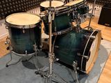 a drum set that is sitting on a rug in a room