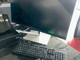 a desk with a computer and a phone on it