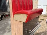 a red bench that is sitting on the back of a truck