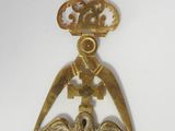 an image of a gold pendant with a bird and a crown on it