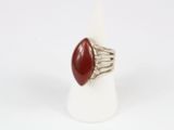 a close up of a ring with a red stone on it
