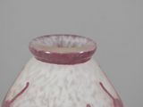a white and pink vase sitting on a table