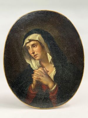 un tableau ovale représentant une femme portant un voile sur la tête