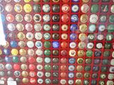 a lot of different colored buttons on a red wall