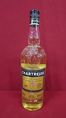 a close up of a bottle of whisky on a red surface