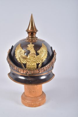 a black and gold helmet with a gold eagle on it