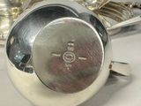 a silver plate with a spoon and spoon rest on it