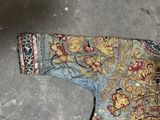 an image of a blue and gold jacket on the floor
