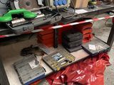 a workbench that has a lot of tools on top of it