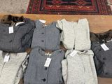 de nombreux vêtements posés par terre à côté d'un tapis