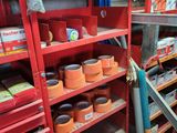 a red shelf filled with lots of items in a store