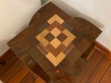 a wooden table with a chess board on top of it