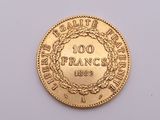 a close up of a gold coin on a white surface