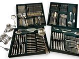 a lot of silverware in a case on the table
