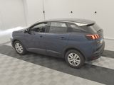 the back end of a blue car parked in a garage