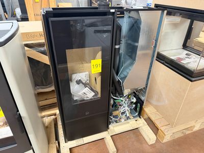 two refrigerators that are sitting on pallets in a room