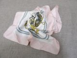 a white and blue scarf with a gold anchor on it