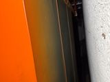 an orange door and a white wall in a room