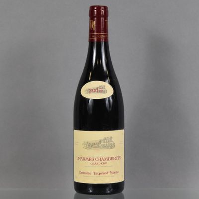 a bottle of wine sitting on top of a table next to a bottle of wine