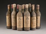 six bottles of wine are lined up in a row on a gray surface