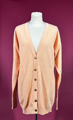 an orange cardigan sweater on a mannequin mannequin mannequin mannequin mannequin mannequin mannequin mannequin mann