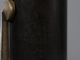 a close up of a metal object with a wooden handle