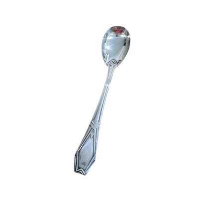 a silver spoon with a red handle on a white background