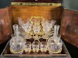 a wooden box with a set of wine glasses in it