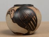 a black and white vase with a bird on it