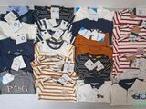 a lot of baby clothes that are on a table