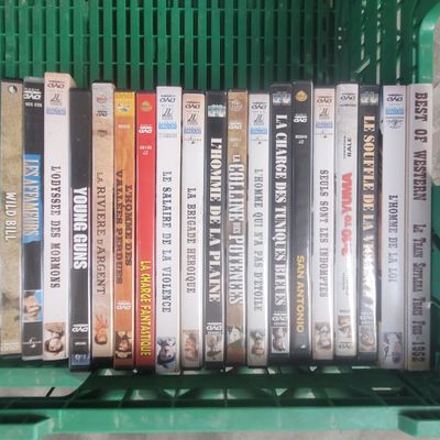 a lot of dvds in a green basket on the shelf