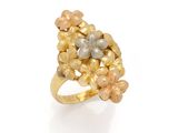 a close up of a gold and silver ring on a white surface