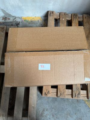 two boxes sitting on a pallet in a room