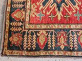 an image of a red, blue and yellow rug with a bird design on it