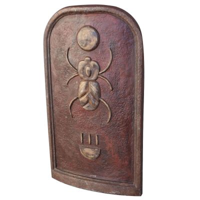 a metal plaque with a bug on it on a white background