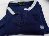 navy blue polo shirt with white collar and logo on the chest