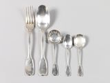 five silver spoons and two silver spoons on a white surface