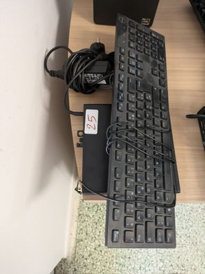 a computer keyboard and mouse on a desk with a mouse pad