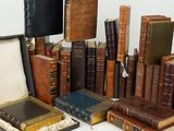 many old books stacked on top of each other