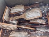 a lot of brushes in a box that are wrapped in plastic