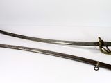 two old swords are sitting side by side on a white surface